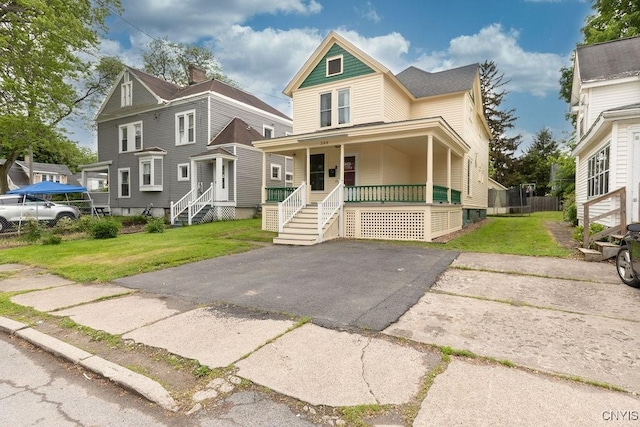 264 S 5th St, Fulton, NY 13069 - victorian-style house featuring covered porch and a front yard