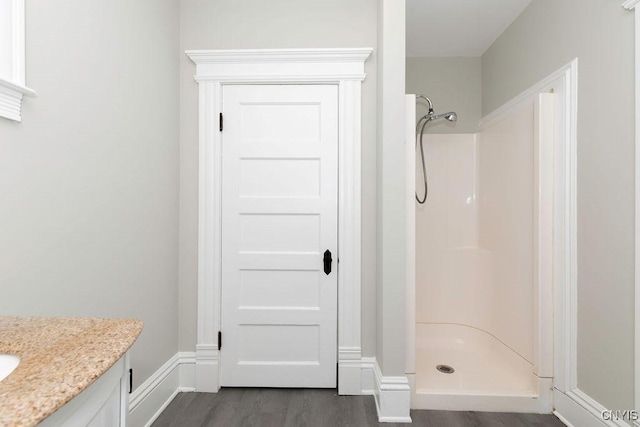 264 S 5th St, Fulton, NY 13069 - full bath with a shower stall, vanity, wood finished floors, and baseboards