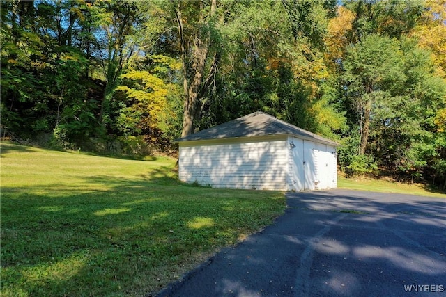 80 Lake St, Urbana, NY 14840 - garage featuring a wooded view and a storage shed