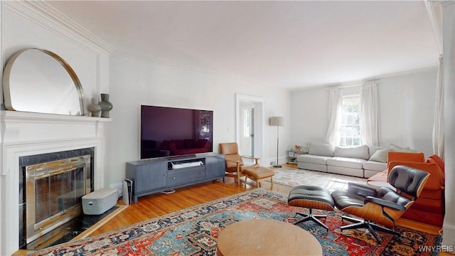 80 Lake St, Urbana, NY 14840 - living area featuring wood finished floors, a glass covered fireplace, and crown molding