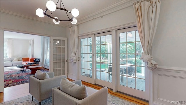 80 Lake St, Urbana, NY 14840 - doorway with light wood-type flooring, crown molding, and a chandelier