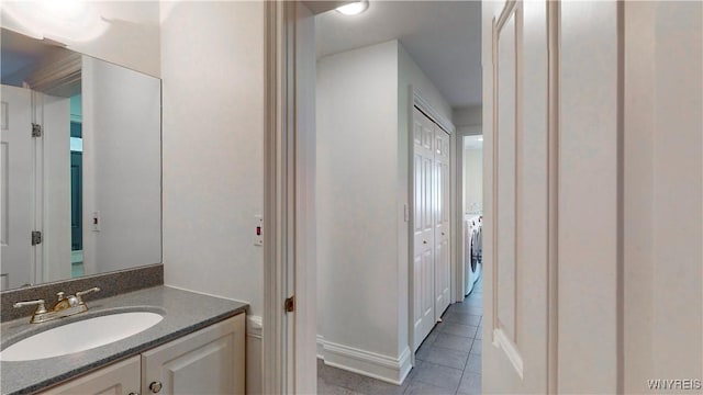 80 Lake St, Urbana, NY 14840 - bathroom featuring tile patterned floors, vanity, and washer / clothes dryer