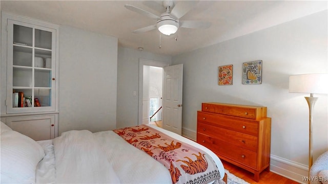 80 Lake St, Urbana, NY 14840 - bedroom with wood finished floors, baseboards, and a ceiling fan