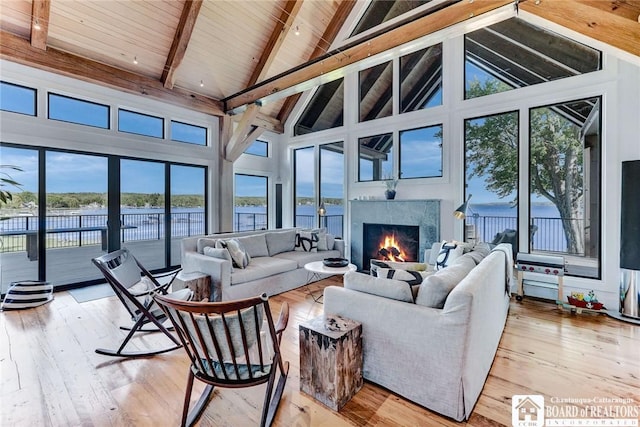 6007 Tinkertown Dr, Chautauqua, NY 14728 - living room with a premium fireplace, high vaulted ceiling, light wood finished floors, plenty of natural light, and wood ceiling with exposed beams