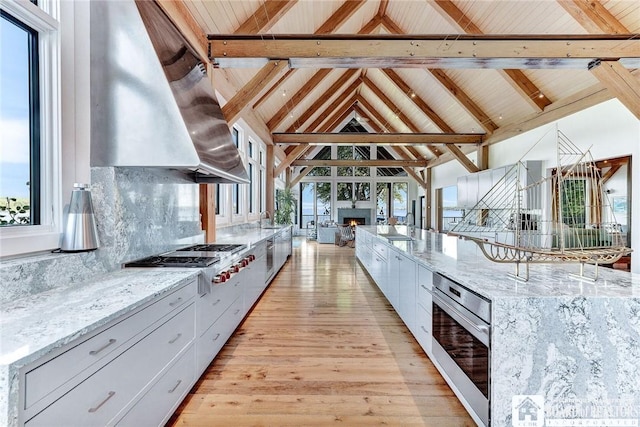 6007 Tinkertown Dr, Chautauqua, NY 14728 - kitchen with appliances with stainless steel finishes, white cabinets, wall chimney exhaust hood, and healthy amount of natural light