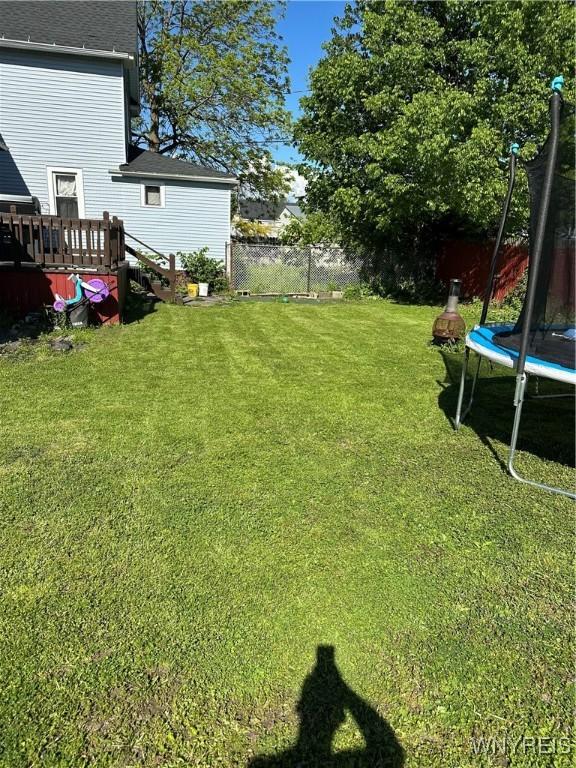 125 Spaulding St, Buffalo, NY 14220 - view of yard featuring a trampoline and a wooden deck