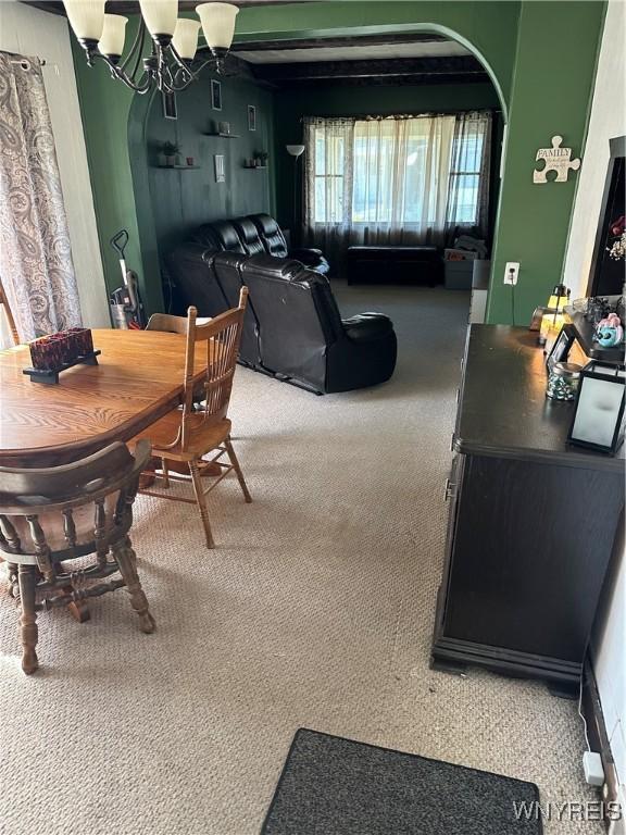125 Spaulding St, Buffalo, NY 14220 - dining space featuring carpet, a chandelier, and arched walkways