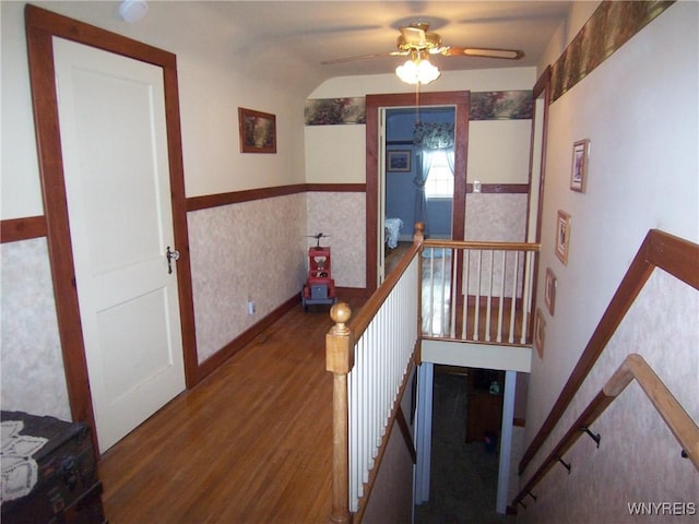 8330 Greiner Rd, Clarence, NY 14221 - stairs with ceiling fan, wood finished floors, a wainscoted wall, and vaulted ceiling