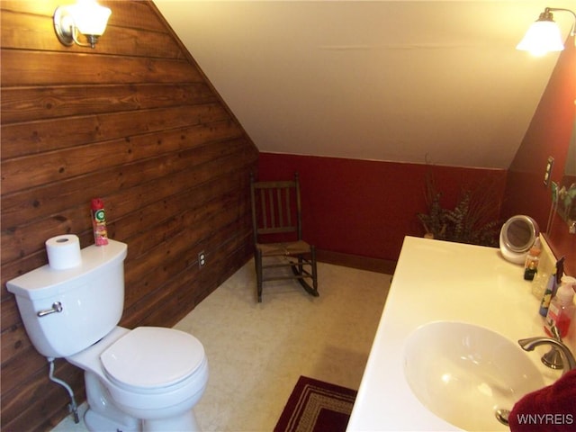 8330 Greiner Rd, Clarence, NY 14221 - bathroom with vaulted ceiling, toilet, wooden walls, and vanity