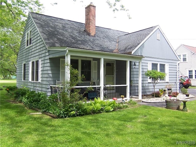 8330 Greiner Rd, Clarence, NY 14221 - back of house with a shingled roof, a lawn, a chimney, and covered porch