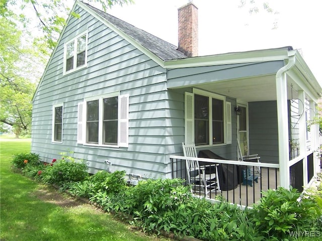 8330 Greiner Rd, Clarence, NY 14221 - view of side of home featuring a chimney and a porch