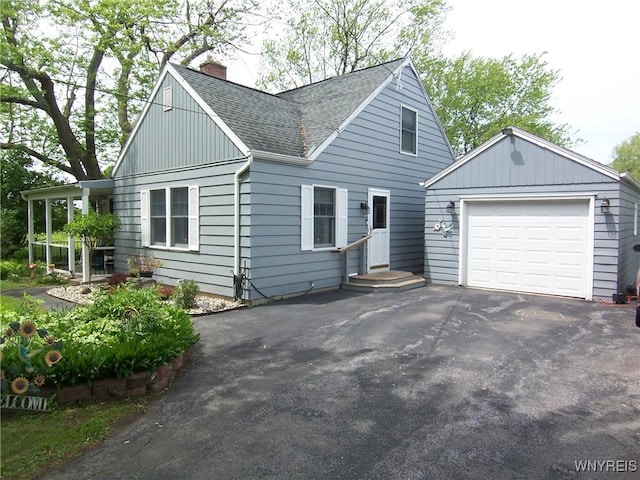 8330 Greiner Rd, Clarence, NY 14221 - view of front of house featuring a chimney, roof with shingles, and asphalt driveway