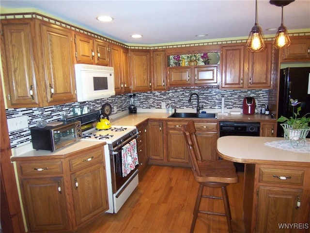8330 Greiner Rd, Clarence, NY 14221 - kitchen featuring black appliances, a sink, light countertops, brown cabinets, and tasteful backsplash