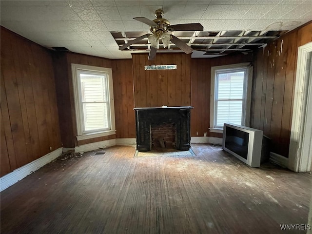 500 Massachusetts Ave, Buffalo, NY 14213 - unfurnished living room featuring wood finished floors, ceiling fan, wooden walls, and baseboards