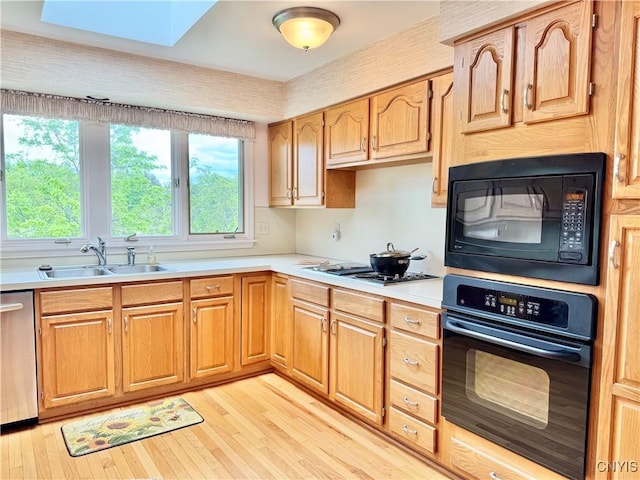 111 Spyglass Ln, Manlius, NY 13066 - kitchen with black appliances, a sink, light countertops, and light wood-type flooring