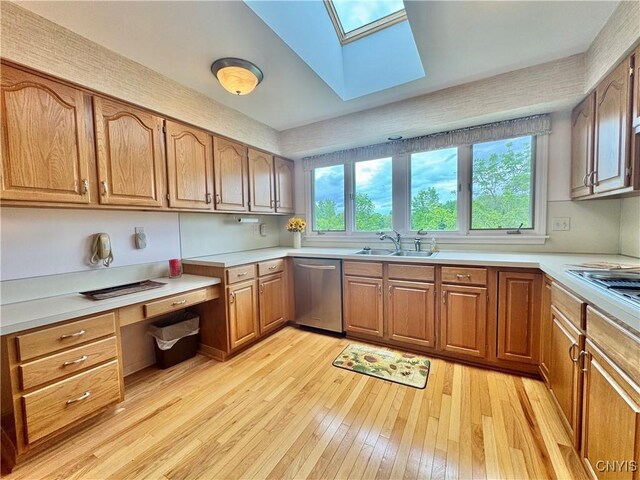 111 Spyglass Ln, Manlius, NY 13066 - kitchen featuring appliances with stainless steel finishes, a sink, light wood-style flooring, a skylight, and light countertops