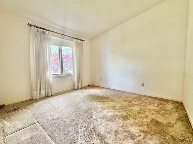 111 Spyglass Ln, Manlius, NY 13066 - spare room featuring carpet, lofted ceiling, and baseboards