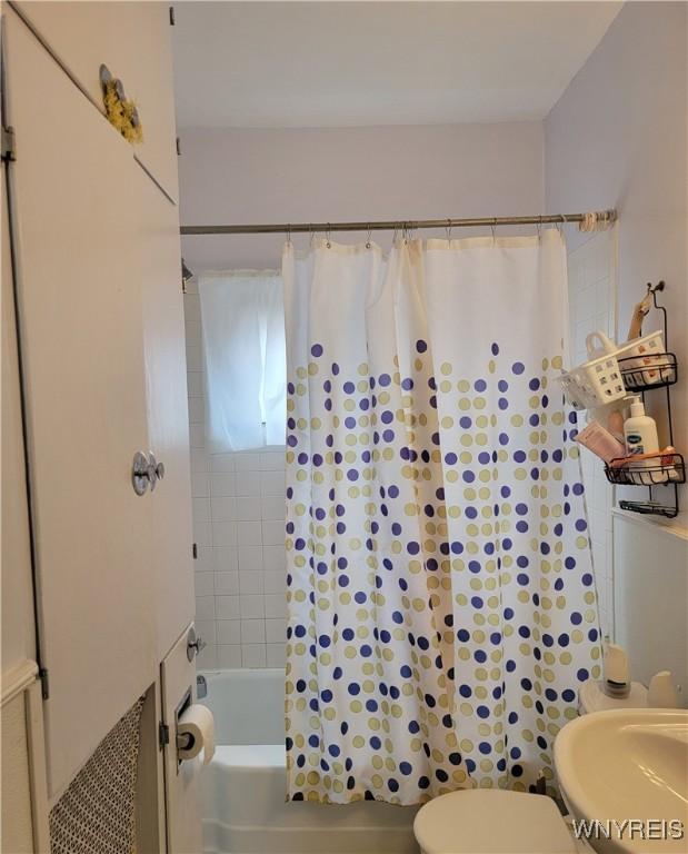 139 Englewood Ave, Buffalo, NY 14214 - bathroom with shower / tub combo, toilet, and a sink