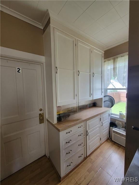 139 Englewood Ave, Buffalo, NY 14214 - kitchen featuring ornamental molding, white cabinets, light wood finished floors, and butcher block countertops