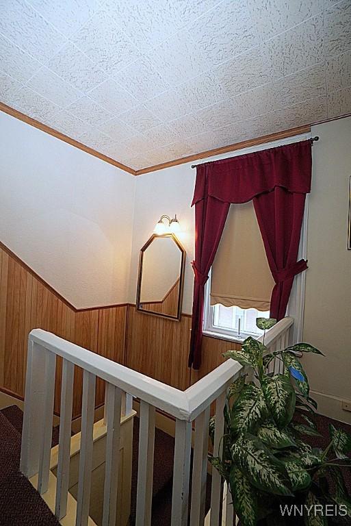 507 N Academy St, Ridgeway, NY 14103 - staircase with wood walls and ornamental molding