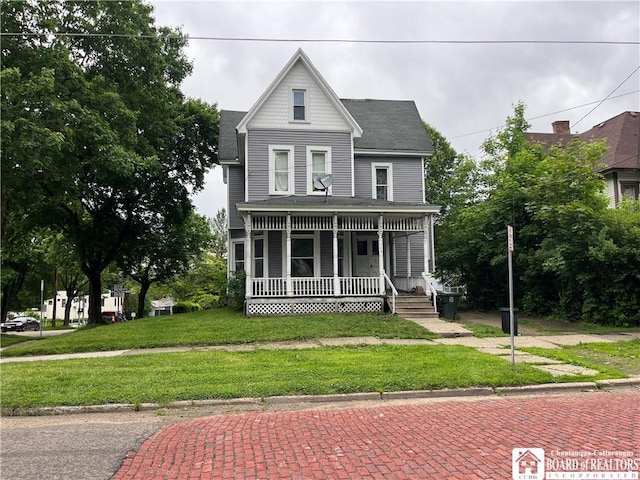 114 W 7th St, Jamestown, NY 14701 - victorian-style house with covered porch, a front lawn, and a shingled roof