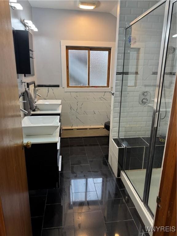 251 Minnesota Ave, Buffalo, NY 14215 - bathroom with double vanity, a stall shower, and a baseboard heating unit