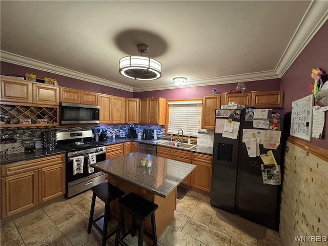 251 Minnesota Ave, Buffalo, NY 14215 - kitchen with appliances with stainless steel finishes, a sink, a kitchen bar, a kitchen island, and decorative backsplash