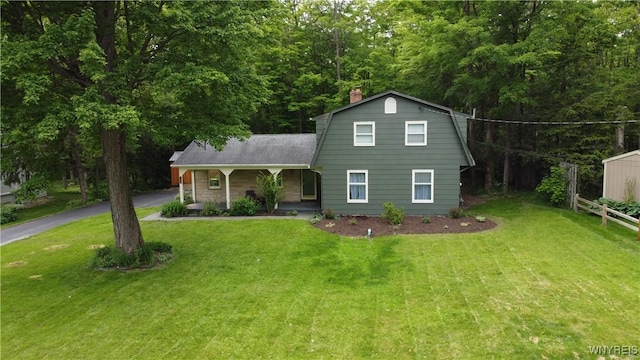 7066 E Ln, Boston, NY 14057 - colonial inspired home featuring a chimney, a gambrel roof, covered porch, asphalt driveway, and a shingled roof
