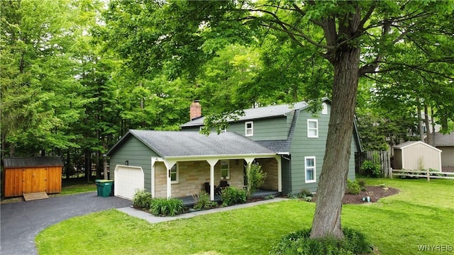 7066 E Ln, Boston, NY 14057 - view of front of home with a porch, a shingled roof, asphalt driveway, a front yard, and a chimney