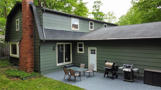 7066 E Ln, Boston, NY 14057 - back of property featuring a patio, a chimney, and roof with shingles
