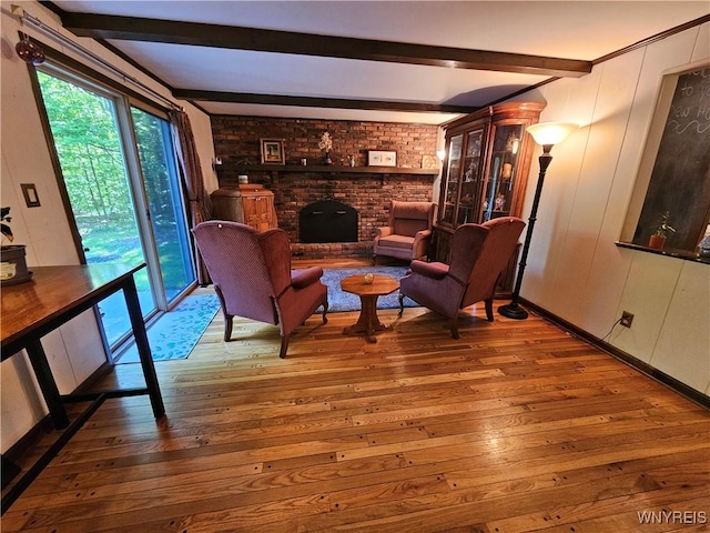 7066 E Ln, Boston, NY 14057 - living room featuring beam ceiling, hardwood / wood-style floors, and a brick fireplace