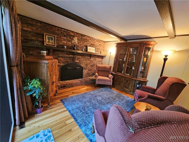 7066 E Ln, Boston, NY 14057 - living area featuring wood-type flooring, beam ceiling, and a brick fireplace