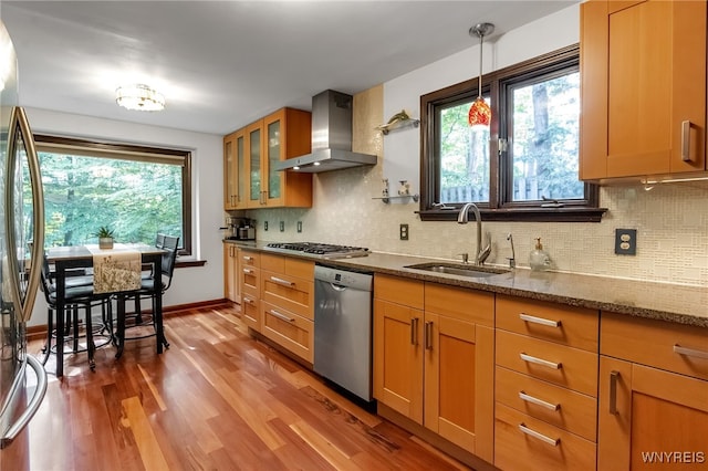 7066 E Ln, Boston, NY 14057 - kitchen with stainless steel appliances, wall chimney range hood, dark stone countertops, wood finished floors, and healthy amount of natural light