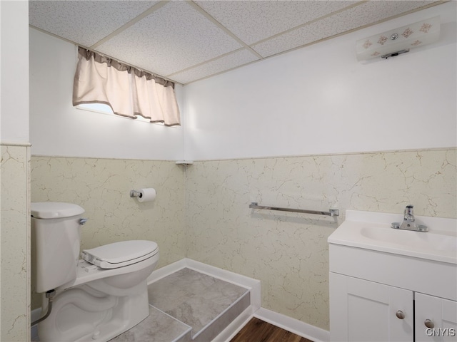 1120 Temple St, Watertown-City, NY 13601 - bathroom featuring vanity, a paneled ceiling, and wood finished floors