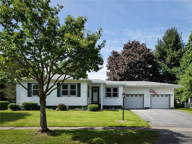 1120 Temple St, Watertown-City, NY 13601 - ranch-style house with a front lawn, driveway, and a garage