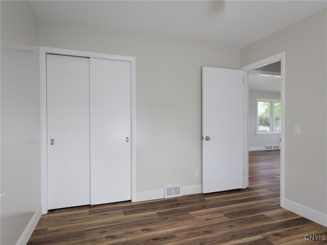 1120 Temple St, Watertown-City, NY 13601 - unfurnished bedroom with dark wood-type flooring, baseboards, a closet, and ceiling fan