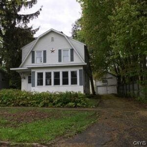 214 W 3rd St S, Fulton, NY 13069 - view of front of house with a gambrel roof and a garage
