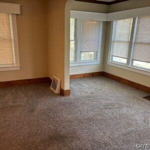 214 W 3rd St S, Fulton, NY 13069 - empty room featuring baseboards and carpet