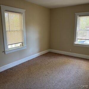 214 W 3rd St S, Fulton, NY 13069 - carpeted empty room with baseboards