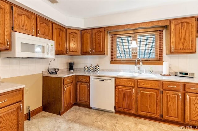 291 Everett Pl, Tonawanda-Town, NY 14150 - kitchen featuring white appliances, a sink, brown cabinets, and decorative backsplash