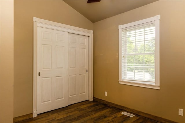 676 County Road 64, Big Flats, NY 14903 - unfurnished bedroom with vaulted ceiling, a closet, and dark wood-style flooring