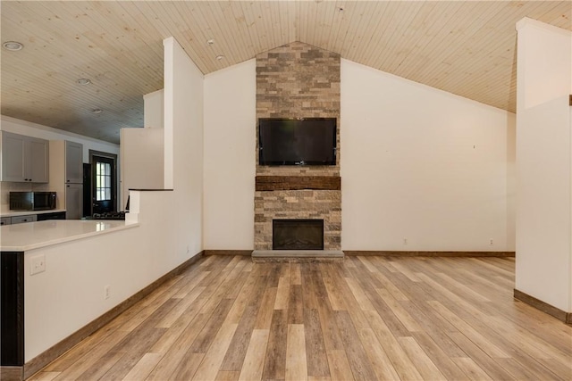 676 County Road 64, Big Flats, NY 14903 - unfurnished living room featuring lofted ceiling, light wood-type flooring, wood ceiling, and a fireplace