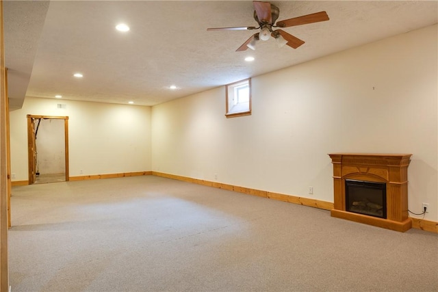 676 County Road 64, Big Flats, NY 14903 - basement featuring recessed lighting, carpet flooring, a glass covered fireplace, and ceiling fan