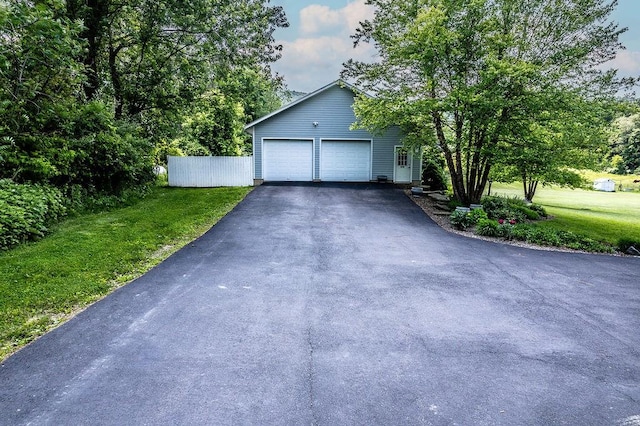 676 County Road 64, Big Flats, NY 14903 - view of front facade featuring asphalt driveway, a front yard, and a garage