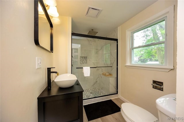 70 Minard St, Lockport-City, NY 14094 - full bath featuring a stall shower, toilet, vanity, wood finished floors, and baseboards