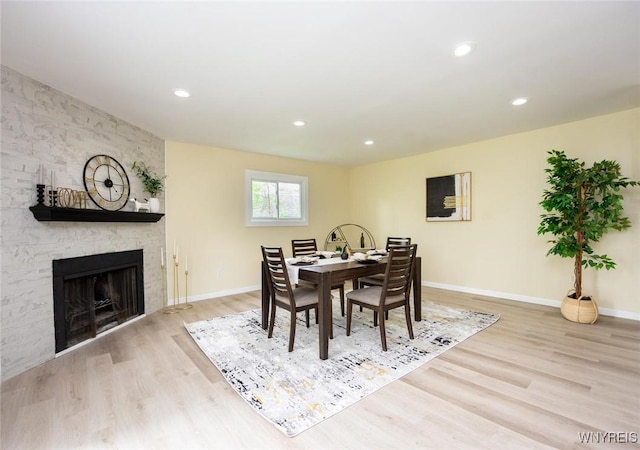 70 Minard St, Lockport-City, NY 14094 - dining space with light wood-style floors, baseboards, a large fireplace, and recessed lighting