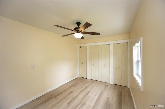 70 Minard St, Lockport-City, NY 14094 - unfurnished bedroom with two closets, baseboards, light wood-style floors, and a ceiling fan