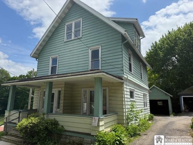 154 Falconer St, Jamestown, NY 14701 - view of front of property featuring a porch, an outbuilding, and a garage