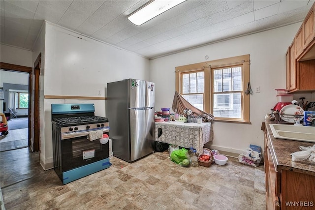 110 Saint Louis Ave, Buffalo, NY 14211 - kitchen with appliances with stainless steel finishes, a sink, stone finish floors, ornamental molding, and dark countertops