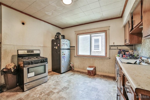 110 Saint Louis Ave, Buffalo, NY 14211 - kitchen with stainless steel appliances, crown molding, light countertops, and brown cabinets